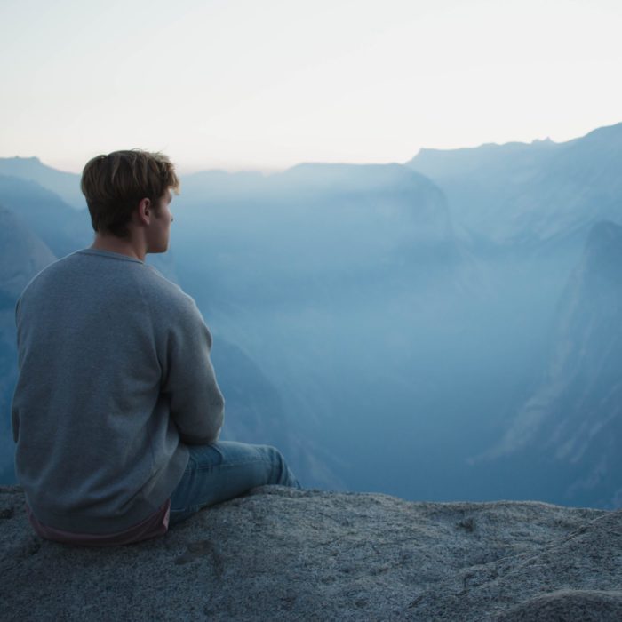 Man Meditating on a Mountain Top