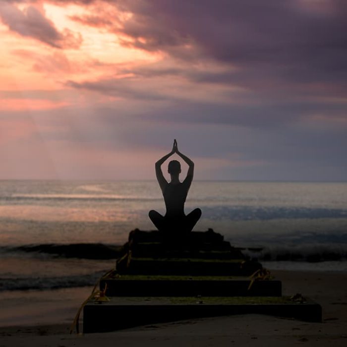 Woman Meditating Near the Beach