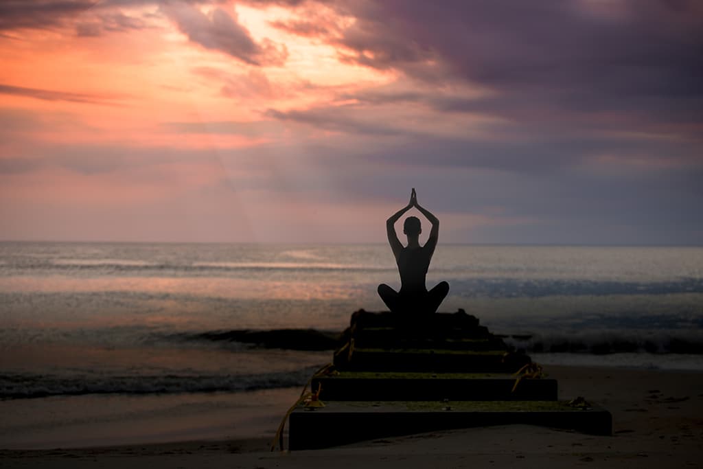Woman Meditating Near the Beach