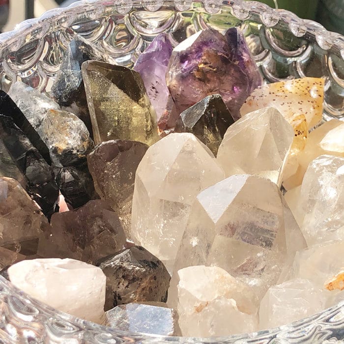 various crystals and quartz on a transparent bowl