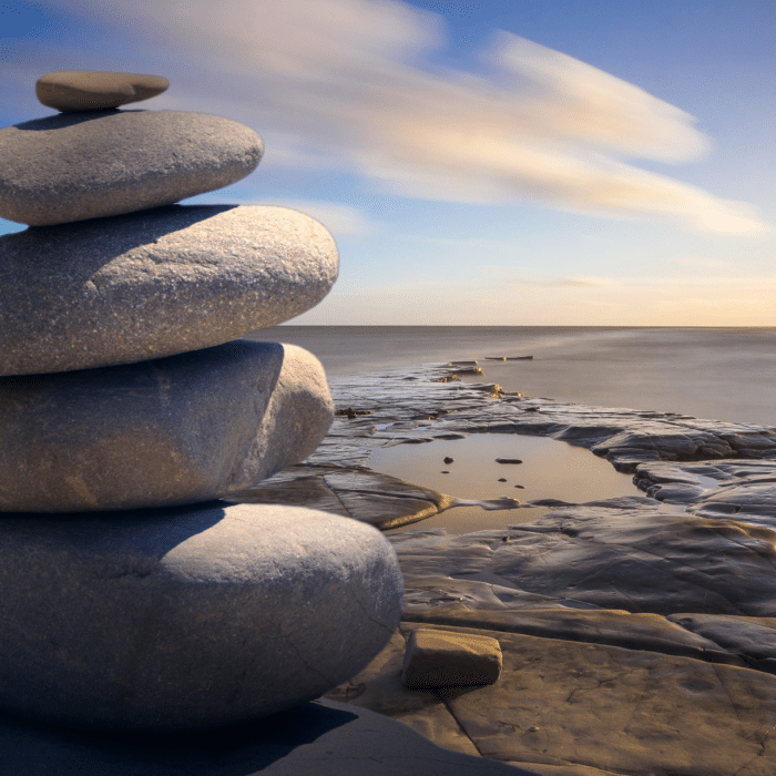 stacked stones by ocean