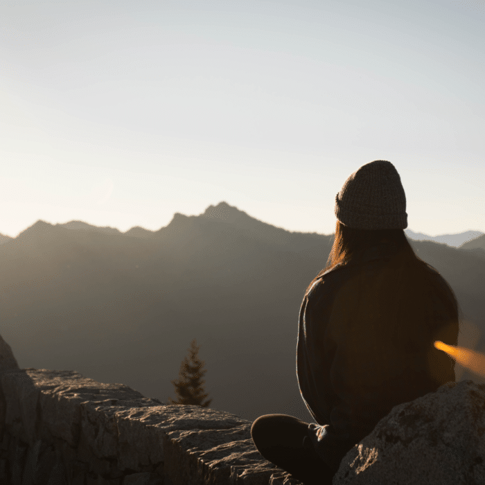 woman meditating on mountain
