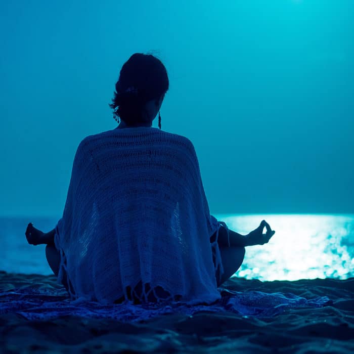 Woman Meditating On A Full Moon