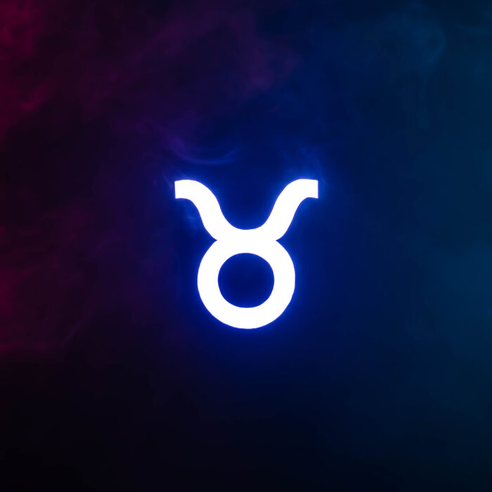 Blue illuminated Taurus zodiac sign with colorful smoke on background