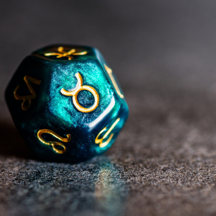 Dice with the symbol of Aries on one of its faces