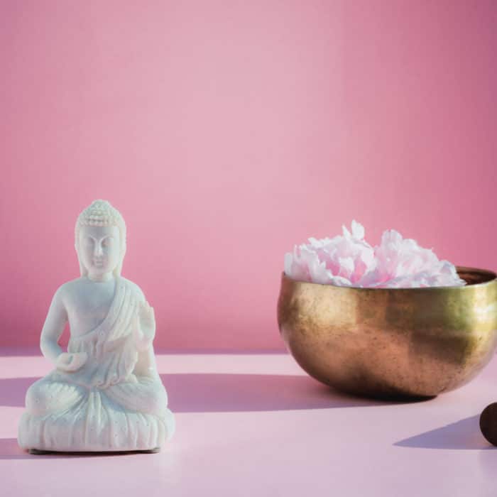 decorative white buddha and singing bowl