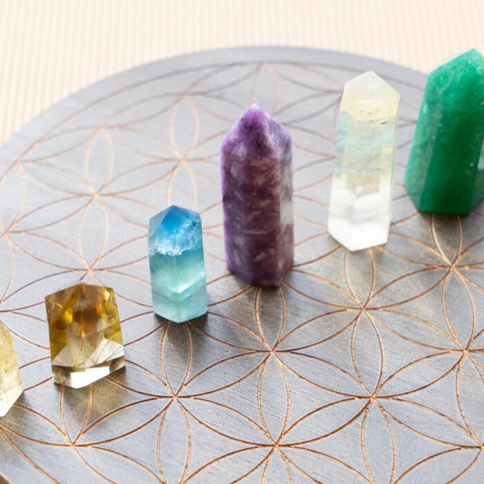 Gemstones minerals obelisks row over life flower chart. Magic healing Rock for Reiki Crystal Ritual, Witchcraft, spiritual esoteric practice