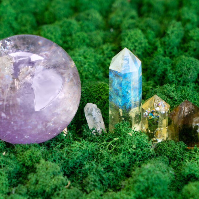Gemstone minerals on mysterious natural forest moss background, quartz, ametist and calcite crystals close up. Magic healing Rock for Reiki Crystal Ritual, Witchcraft, spiritual esoteric practice