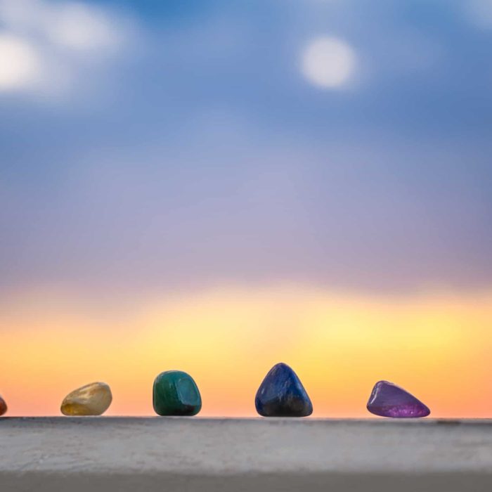 different crystals on a slab of stone at sunset