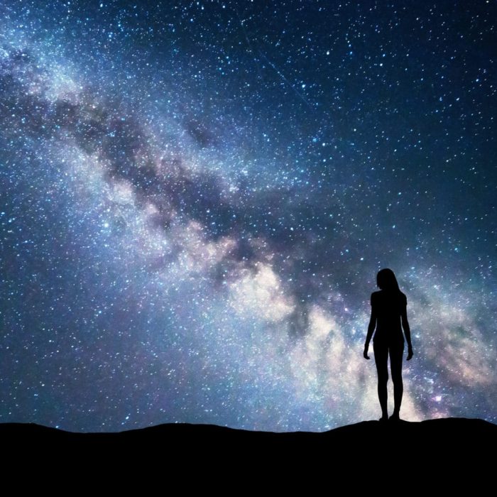 Amblygonite Uses and Benefits Purpose of life, woman standing with Milky Way galaxy in the background
