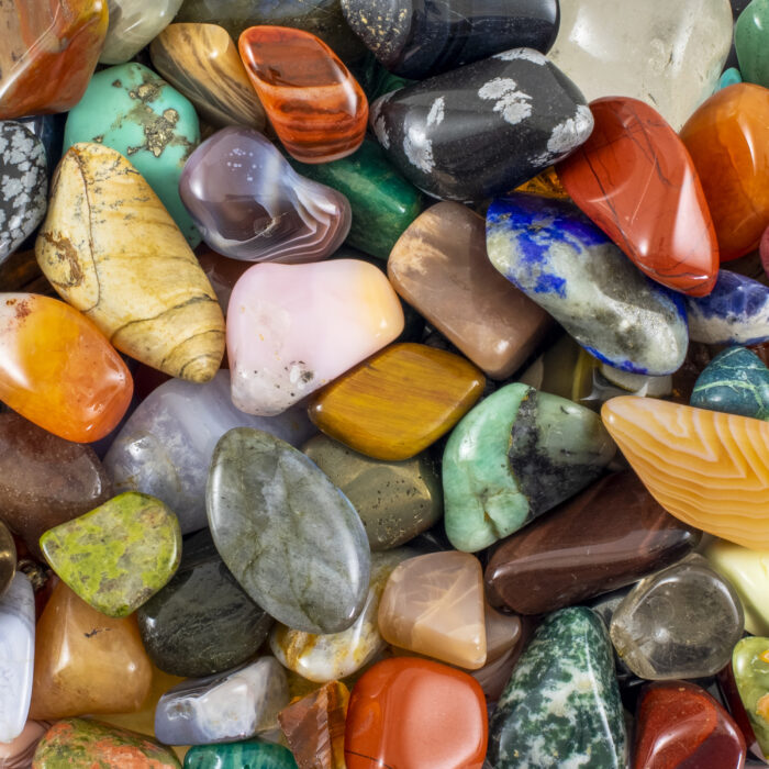 A pile of colorful, shiny stones with patterns on them - perfect for background