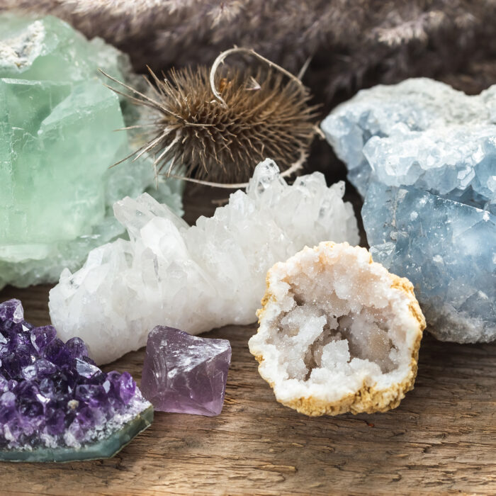 Group of Raw Natural Mineral Stones and Crystals. Green Fluorite, Blue Celestine, Clear Quartz Geode and Amethyst Cluster