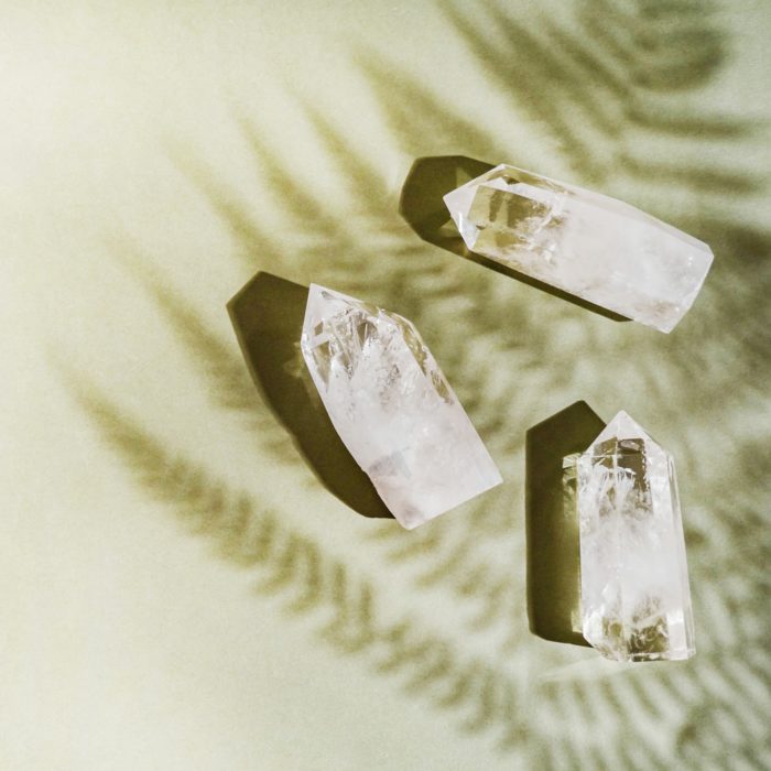 three large quartz with shadow of plant on a green badkgropund