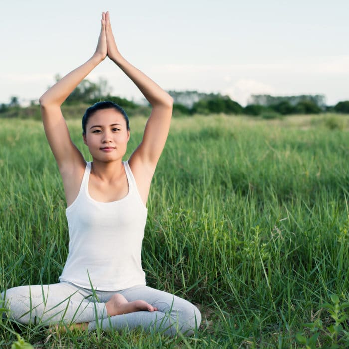young yoga woman sit meditation in the meadows.