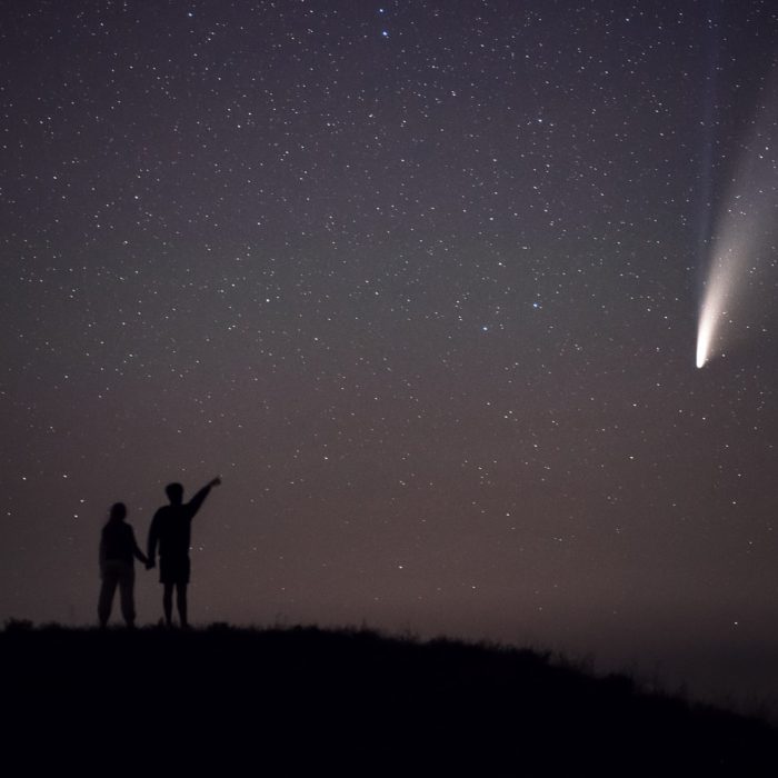 a young man and girl looking at the stars