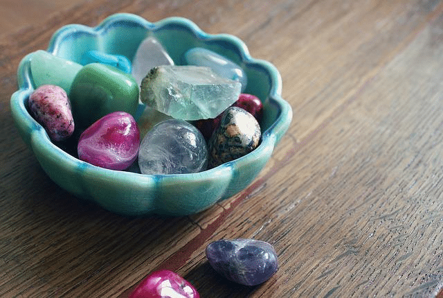 different crystal stones on a turquoise decorative bowl