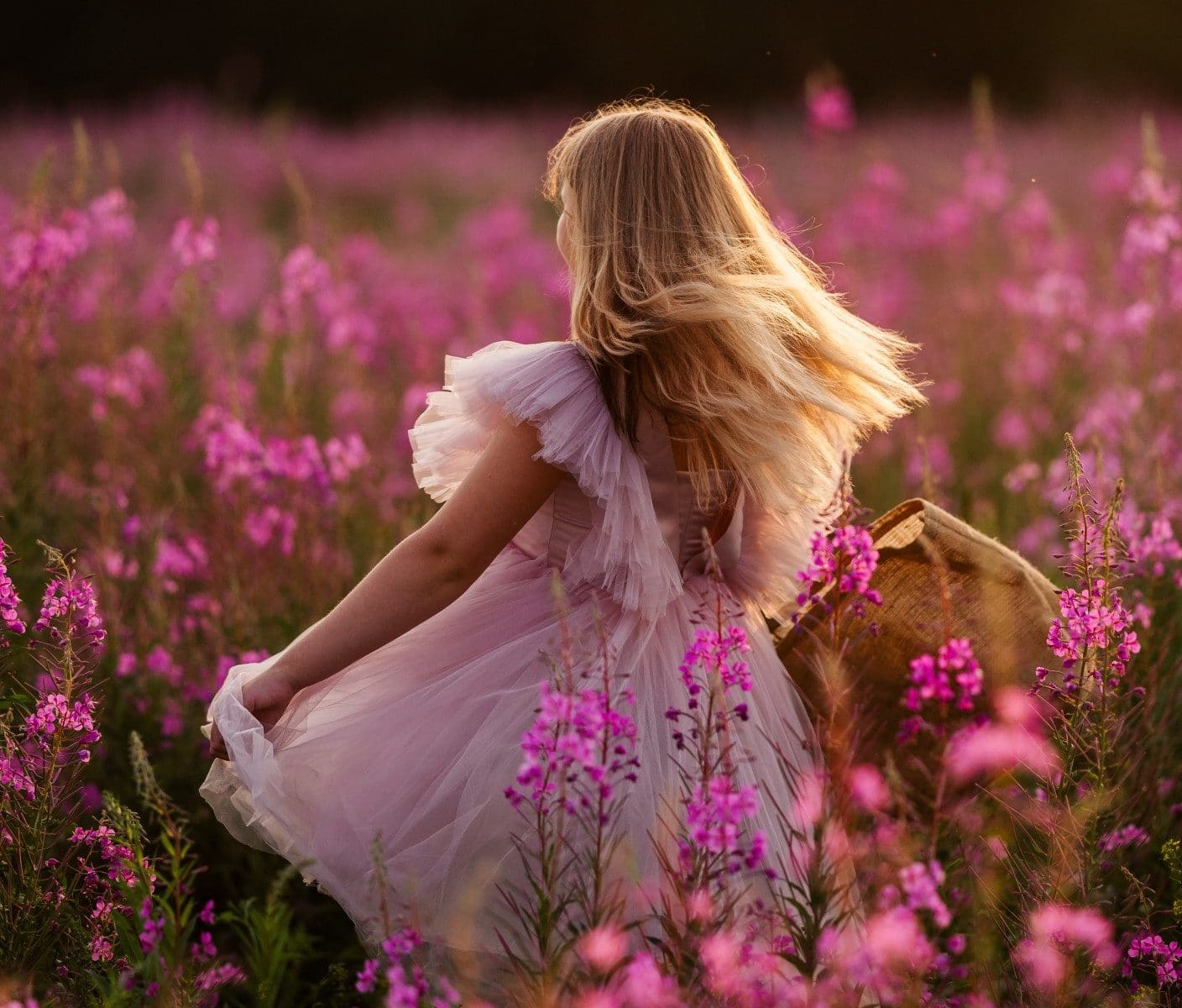 girl in pink dress in a pink field of flowers