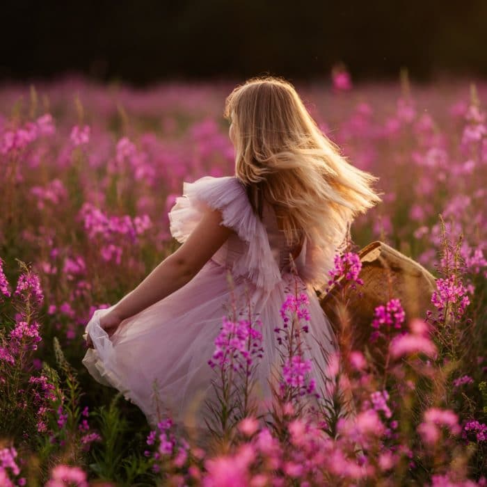 girl in pink dress in a pink field of flowers