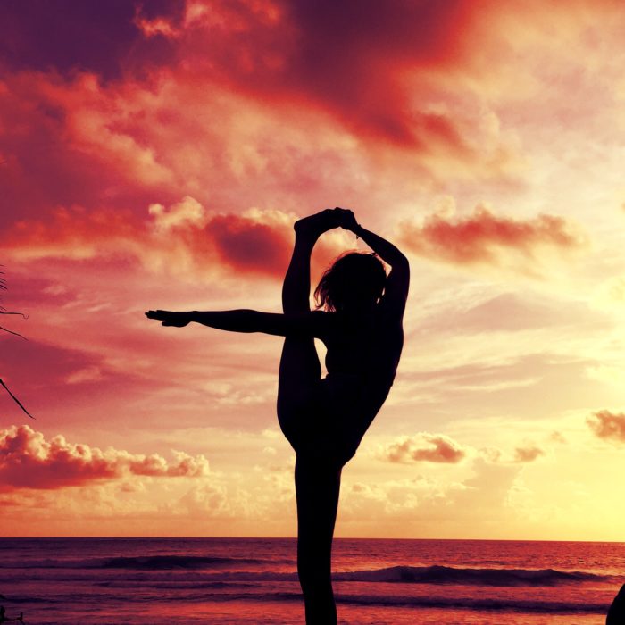 yoga meditation by the ocean at sunset