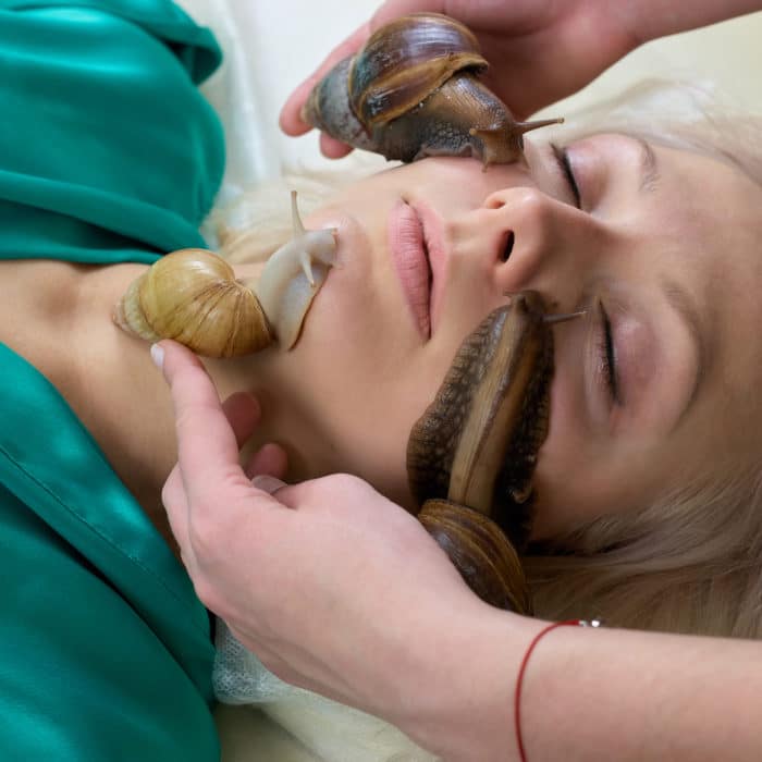 Young woman receiving snails massage.