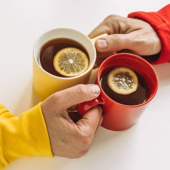 couple holding mugs of tea