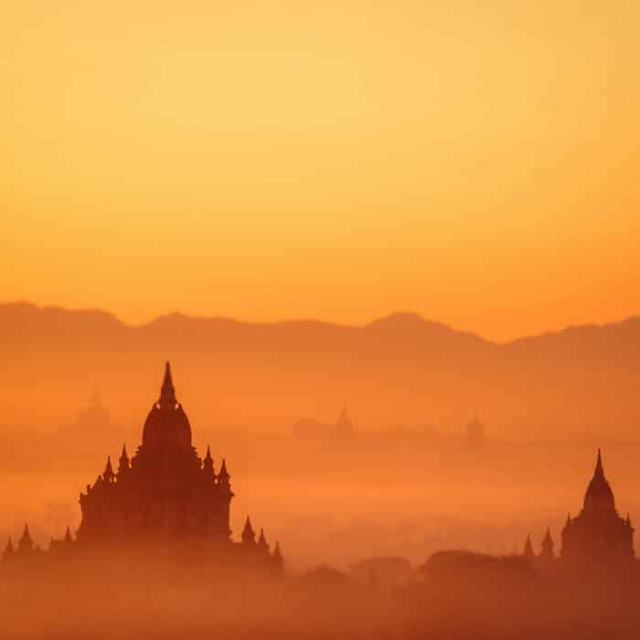 Amazing misty sunrise colors and silhouettes of ancient Sulamani and Tha Beik Hmauk Gu Hpaya. Architecture of old Buddhist Temples at Bagan Kingdom. Myanmar (Burma)