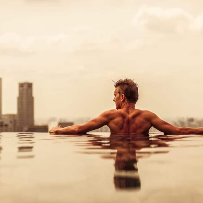 back of man in infinity pool in Singapore