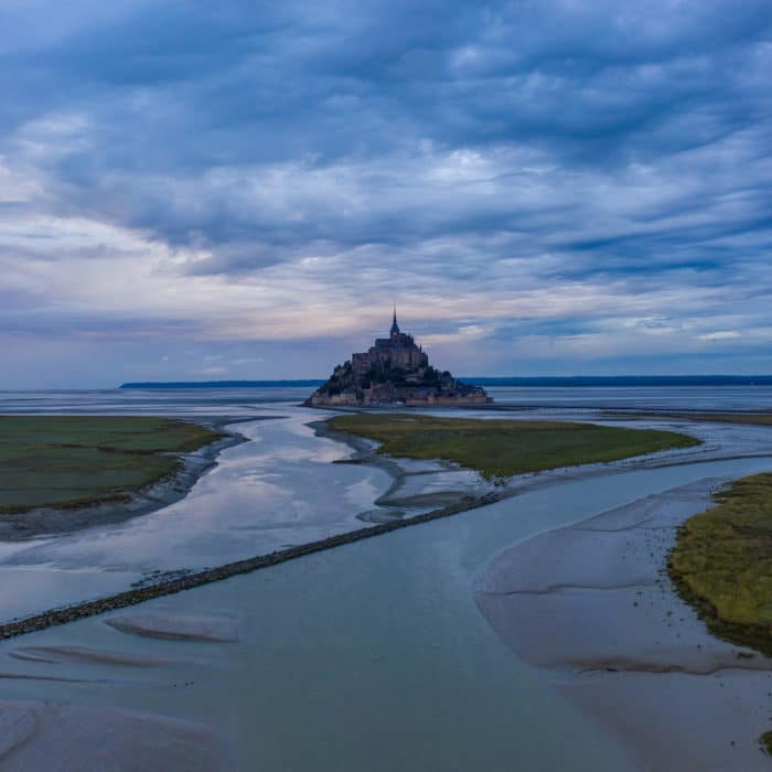 Le Mont Saint Michel, France Castle in Ocean at Sunrise or Sunset, Mystical Horror look of spooky castle in Sea