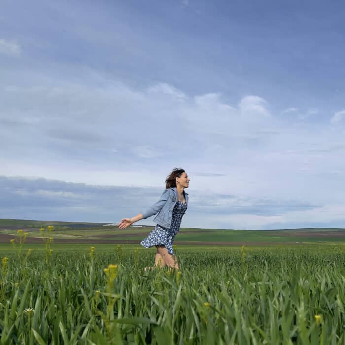 Woman running in a grassland meadow