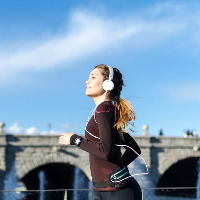 Healthy happy woman jogging running outdoor listening music