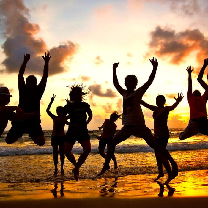 jump shot silhouettes of young people at sunset