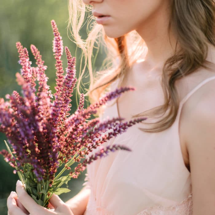 pretty woman holding lavender flowers