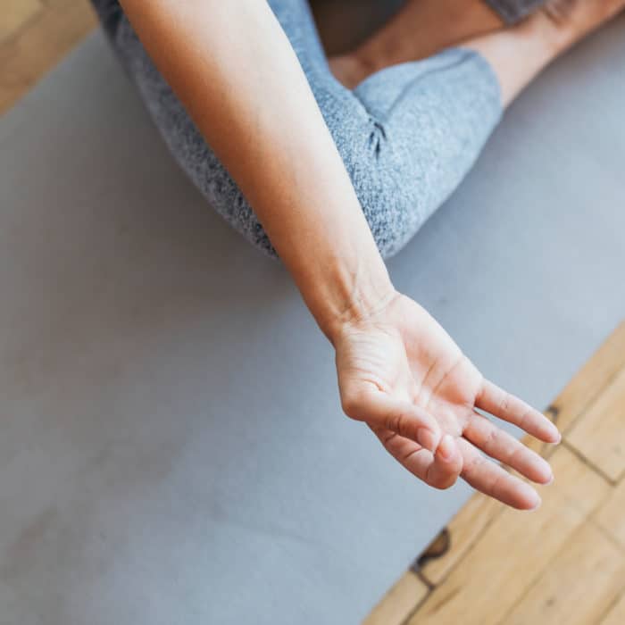 Detail of a person's hand while meditating