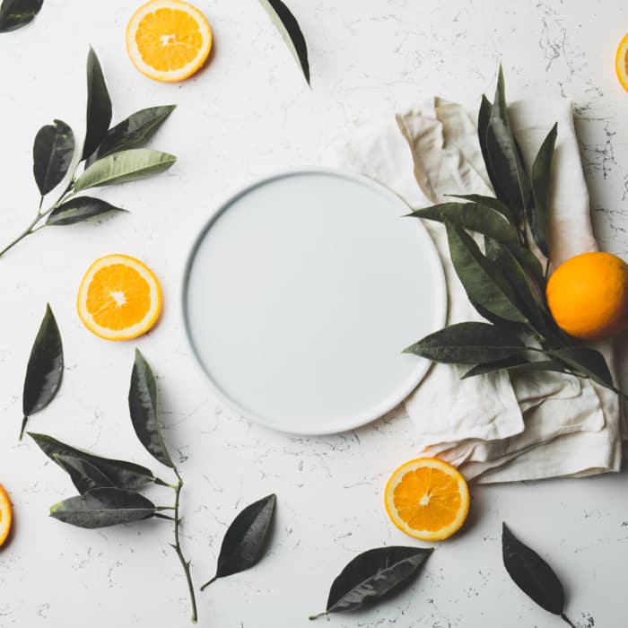 orange slices and leaves on white background