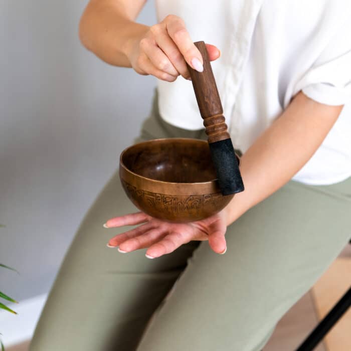 Person holding a singing bowl