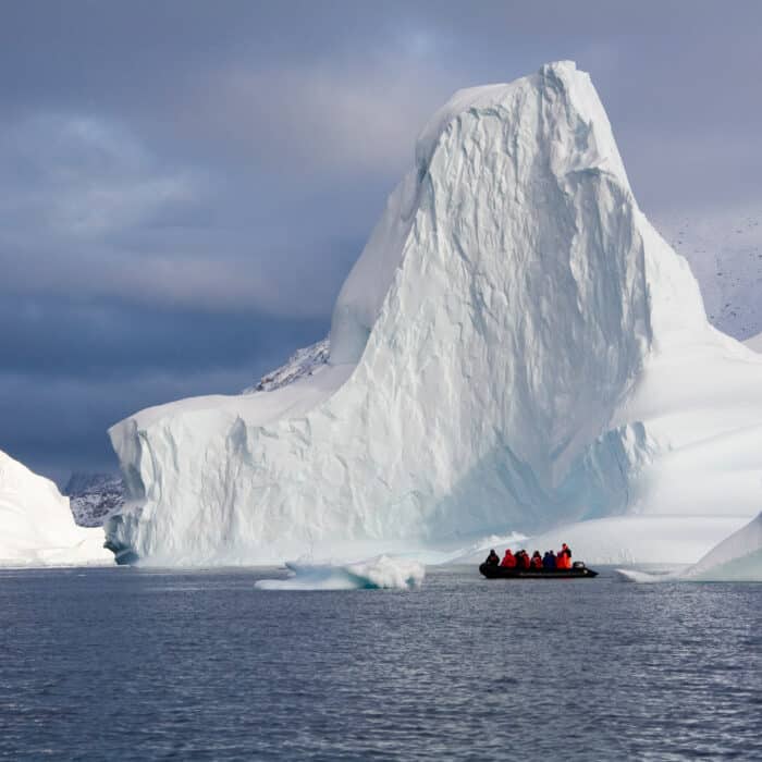 Adventure tourists and Iceberg in Scoresbysund in eastern Greenland