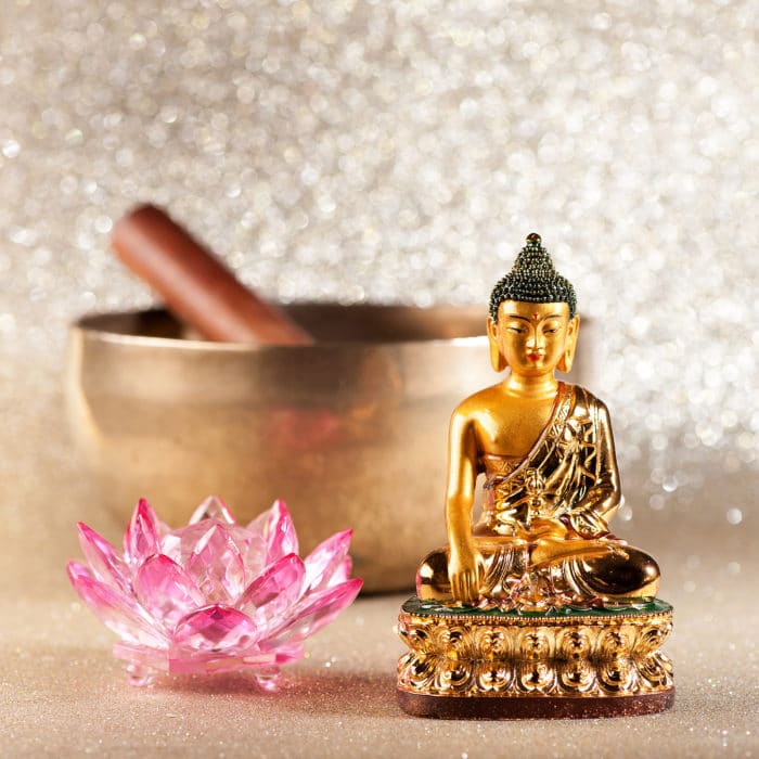 Singing Bowl, lotus flower and Buddha statue. meditation concept