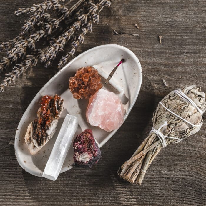 White Ceramic Incense Holder Tray with Mineral Crystal Stones and Aroma Stick. Bundle of Salvia Sage and Lavender on the Wooden Rustic Background. Top View with Copy Space