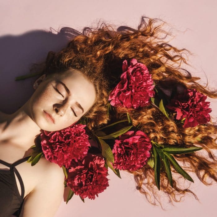 woman laying down with flowers