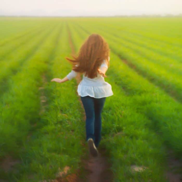 young woman running on the field