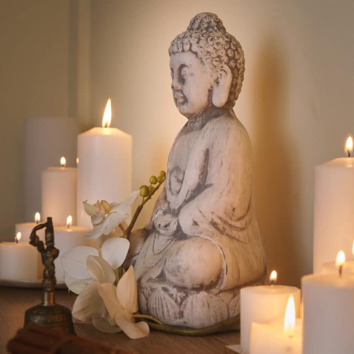 Meditation concept, Buddha figure among candles