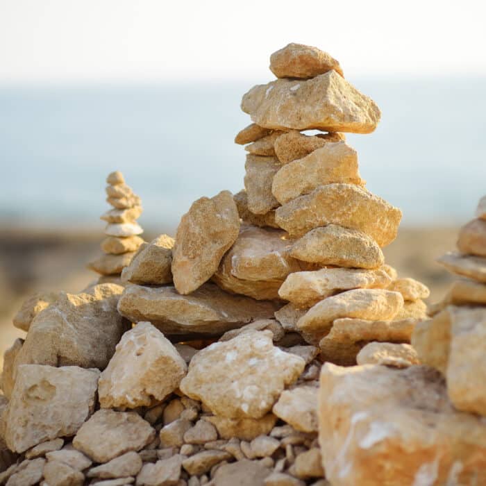 Cairn of stones in desert hills on Cyprus pyramid