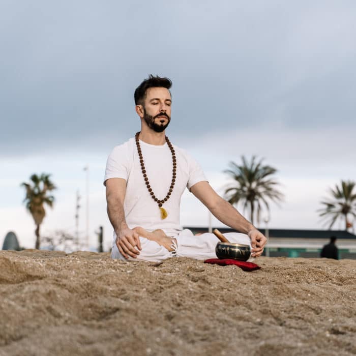 Man meditating at the beach