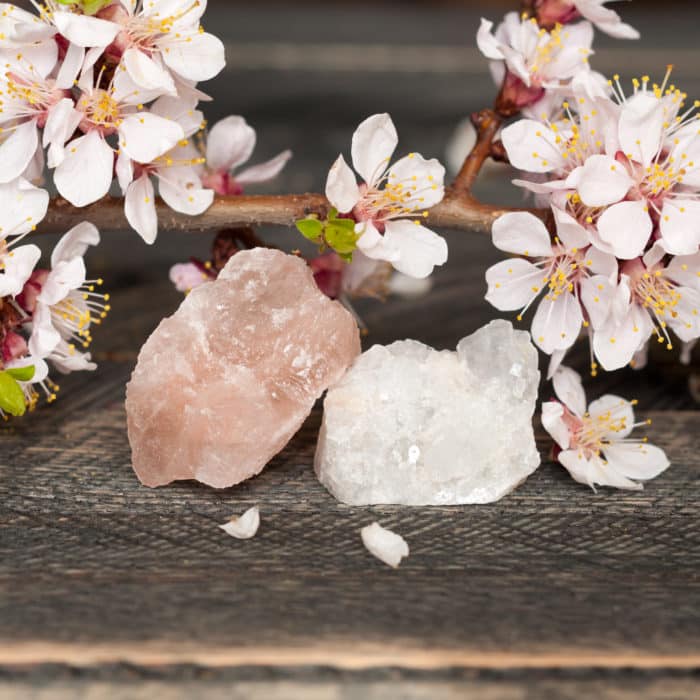 Flowers and minerals are white and pink quartz on wood