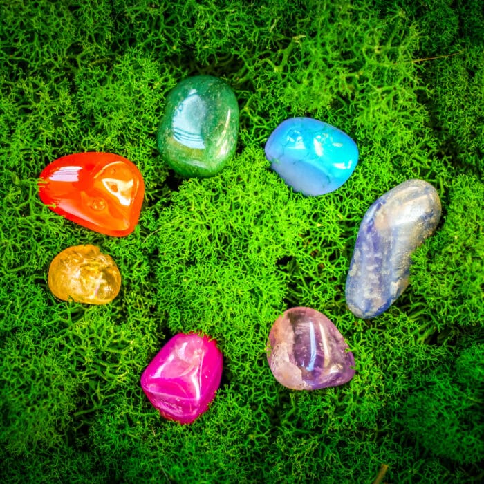 Healing crystals set rainbow circle on moss background, magic healing Rock for Reiki Crystal Ritual, Witchcraft, spiritual esoteric practice