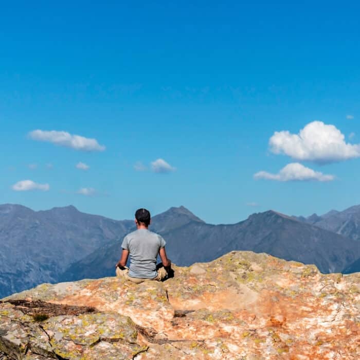 Man meditating in the mountains