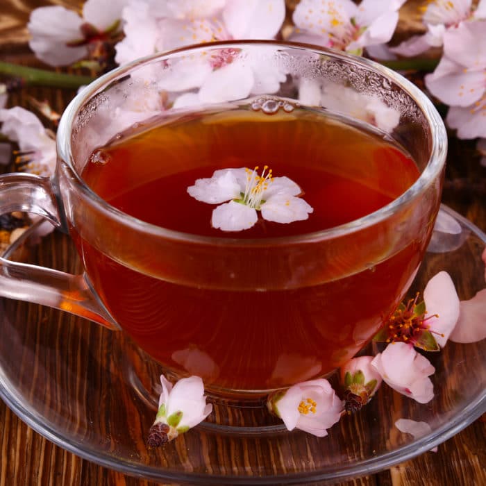 Tea and a branch of cherry blossoms, relaxation concept