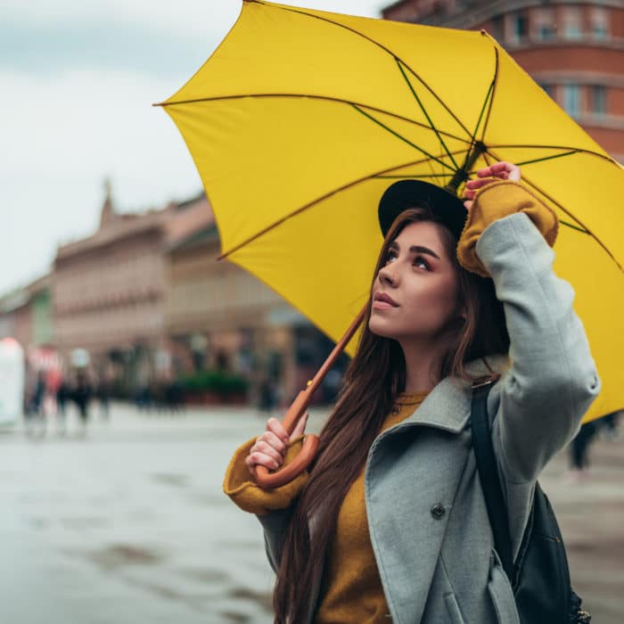 Woman with yellow umbrella out in the city