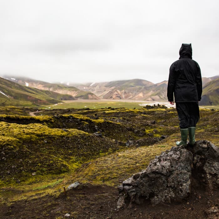 Female Hiker Standing On Rock While Enjoying Nature At Iceland