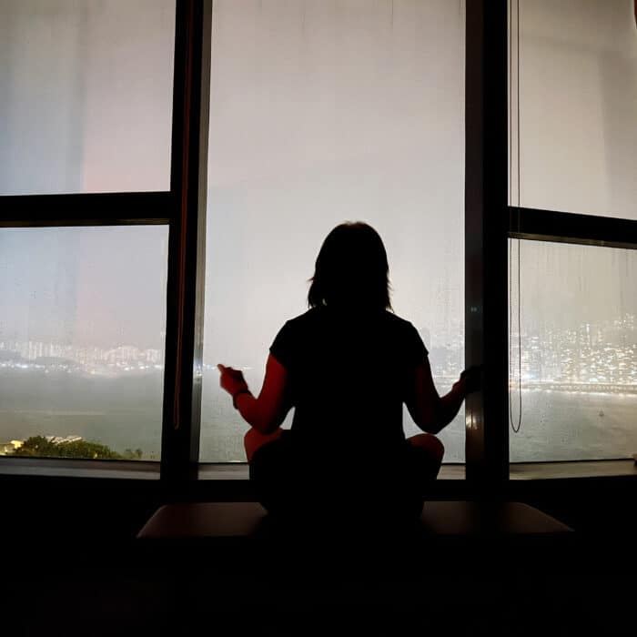 Woman meditating near a window